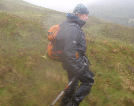 Hillwalker in cloud and heavy rain - properly equipped for conditions