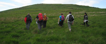 Group of walkers climbing Conic Hill near Loch Lomond